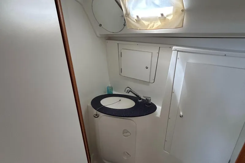 Slide: The Image of Bathroom interior of 2007 Beneteau Cyclades 50.3 yacht, featuring sink and storage cabinets. - 23