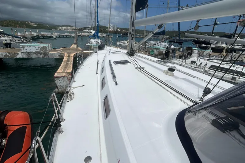 Slide: The Image of 2007 Beneteau Cyclades 50.3 sailboat docked at marina, showcasing deck and rigging. - 6