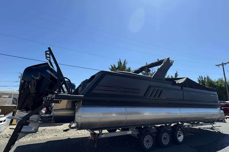 Slide: The Image of 2026 Viaggio Diamante UWA pontoon boat on trailer under clear blue sky. - 2