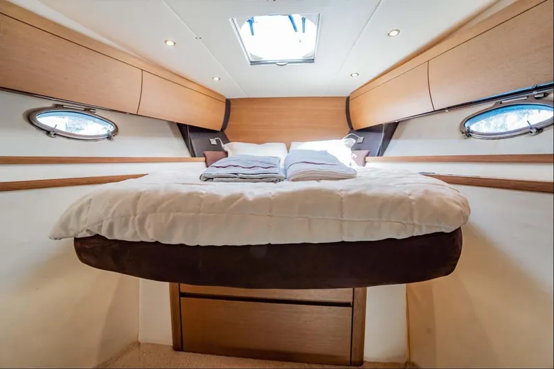 Slide: The Image of Luxurious cabin interior of 2011 Azimut Atlantis 40 yacht with cozy bed and porthole windows. - 16