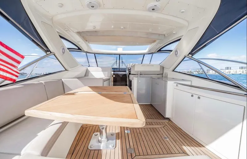 Slide: The Image of Interior of 2011 Azimut Atlantis 40 yacht with wooden table and seating area. - 27