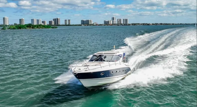 Slide: The Image of Azimut Atlantis 40 yacht cruising on open water, city skyline in background, 2011 model. - 41