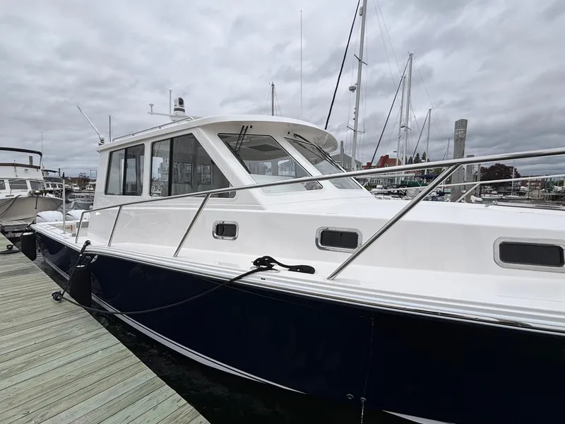 Slide: The Image of 2026 NorthCoast 415 HT boat docked at marina under cloudy skies. - 2