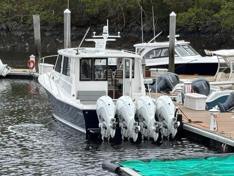Slide: The Image of 2026 NorthCoast 415 HT boat docked with four outboard engines. - 3