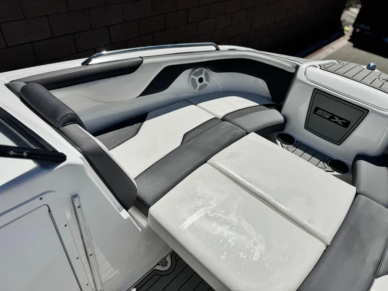 Slide: The Image of 2021 Yamaha SX210 boat interior with cushioned seating and cup holders. - 14