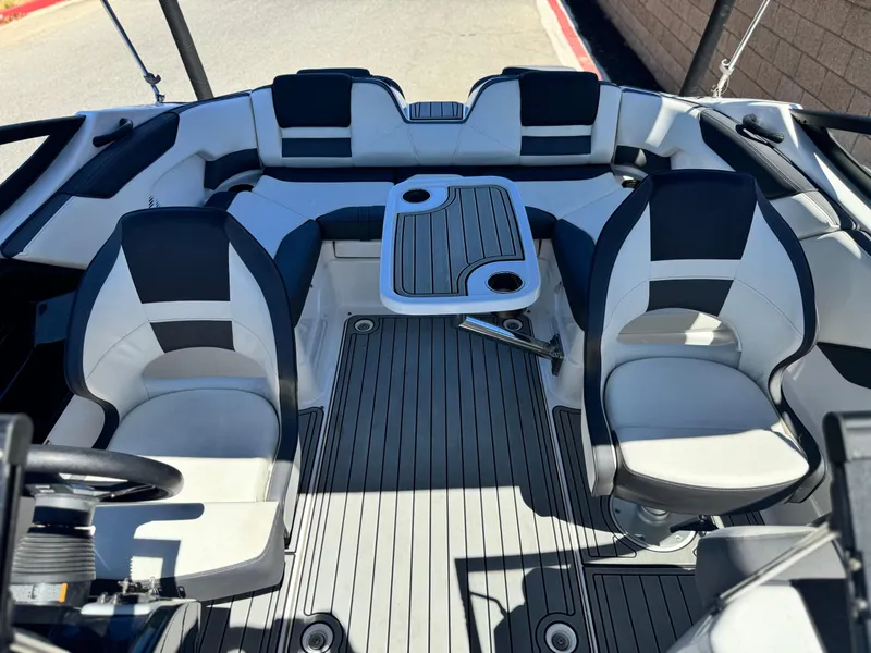 Slide: The Image of 2021 Yamaha Boats SX210 interior with seating and table, featuring modern design and comfort. - 16