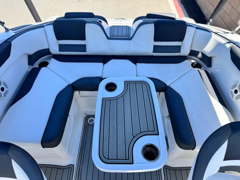 Slide: The Image of 2021 Yamaha SX210 boat interior with cushioned seating and table. - 17