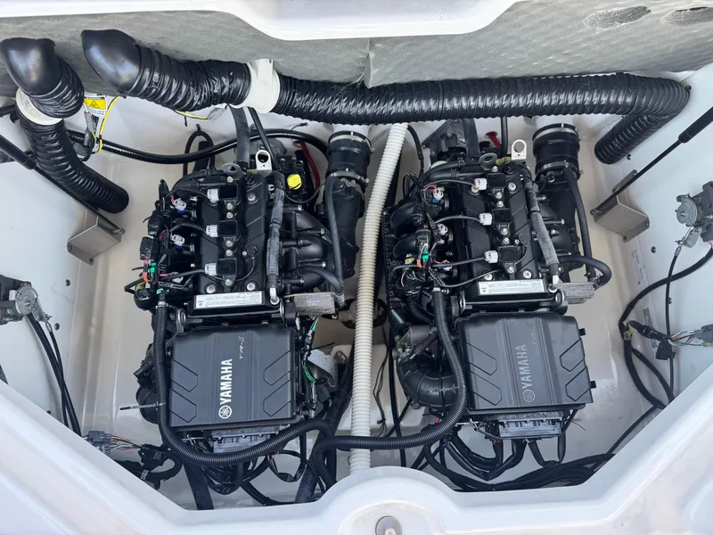 Slide: The Image of Twin engines of a 2021 Yamaha Boats SX210, showcasing intricate wiring and components. - 19