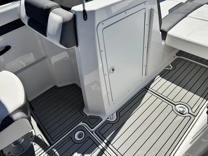 Slide: The Image of 2021 Yamaha Boats SX210 interior with sleek seating and modern flooring design. - 20