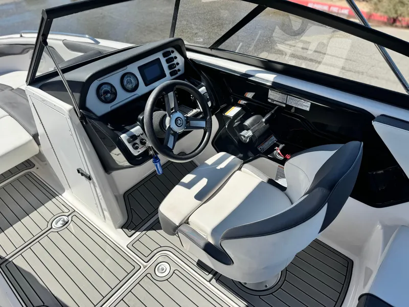 Slide: The Image of 2021 Yamaha Boats SX210 cockpit with steering wheel and control panel. - 22