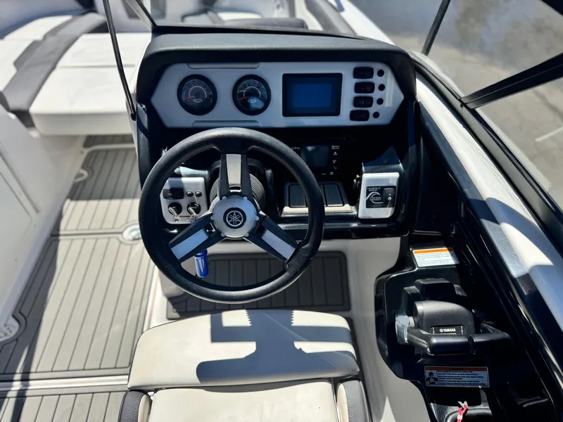 Slide: The Image of 2021 Yamaha Boats SX210 dashboard with steering wheel and control panel. - 23