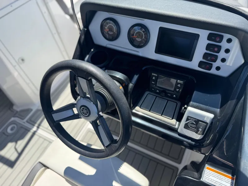 Slide: The Image of 2021 Yamaha Boats SX210 dashboard with steering wheel and control panel. - 24