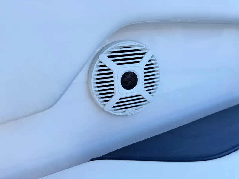 Slide: The Image of Speaker on 2021 Yamaha SX210 boat interior, featuring sleek white design. - 28