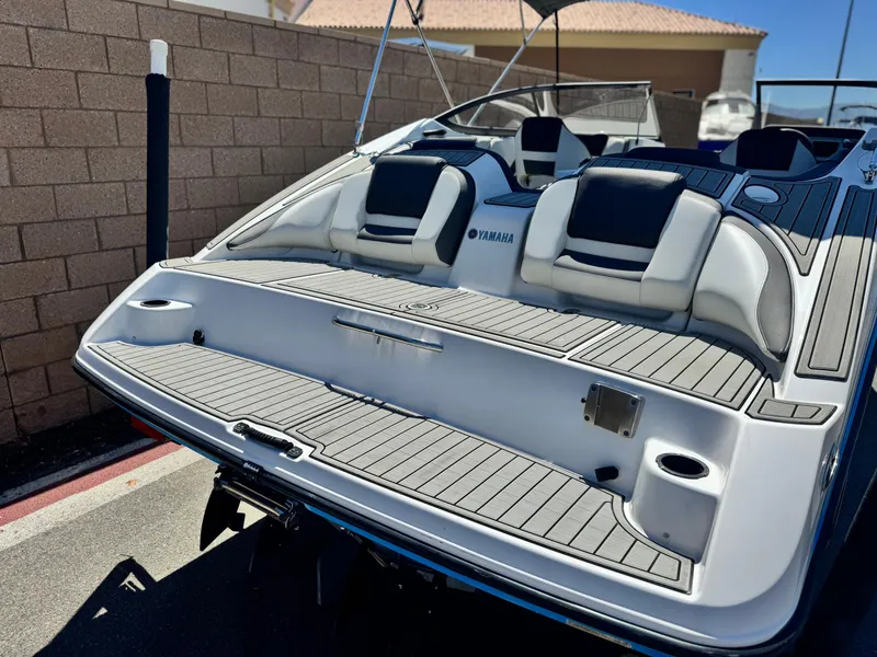 Slide: The Image of 2021 Yamaha Boats SX210, rear view, showcasing spacious seating and sleek design. - 6