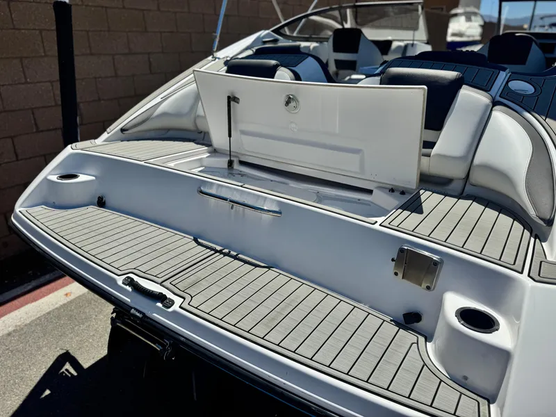 Slide: The Image of 2021 Yamaha Boats SX210 rear deck with seating and storage compartment. - 7