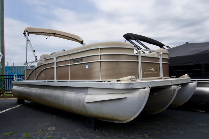 The Image of 2012 Bennington 24 SSL pontoon boat with canopy, parked on pavement. - 0