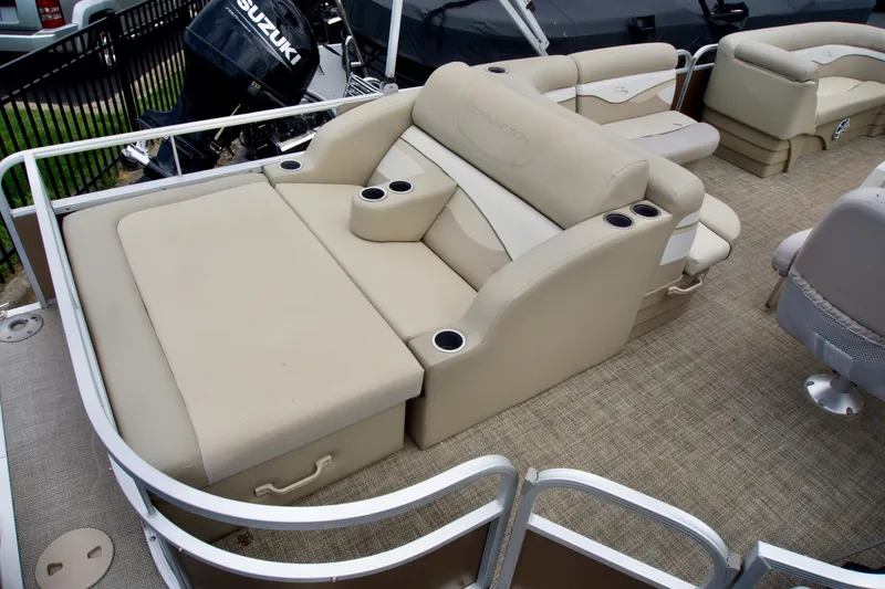 Slide: The Image of 2012 Bennington 24 SSL pontoon boat interior with beige seating and cup holders. - 3