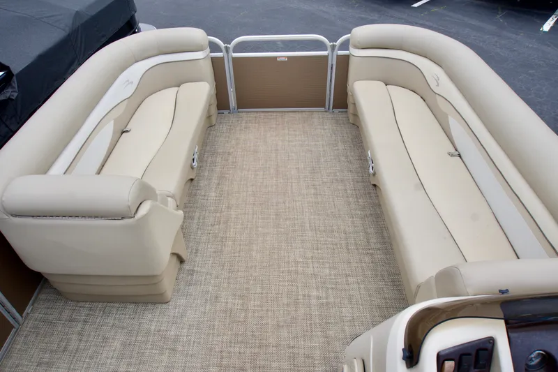 Slide: The Image of 2012 Bennington 24 SSL pontoon boat interior with beige seating and carpeted floor. - 4
