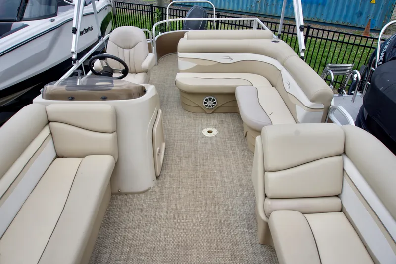 Slide: The Image of 2012 Bennington 24 SSL pontoon boat with beige seating and spacious interior layout. - 5