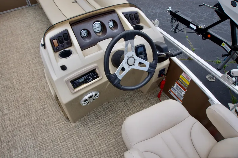 Slide: The Image of 2012 Bennington 24 SSL boat dashboard with steering wheel and controls. - 6