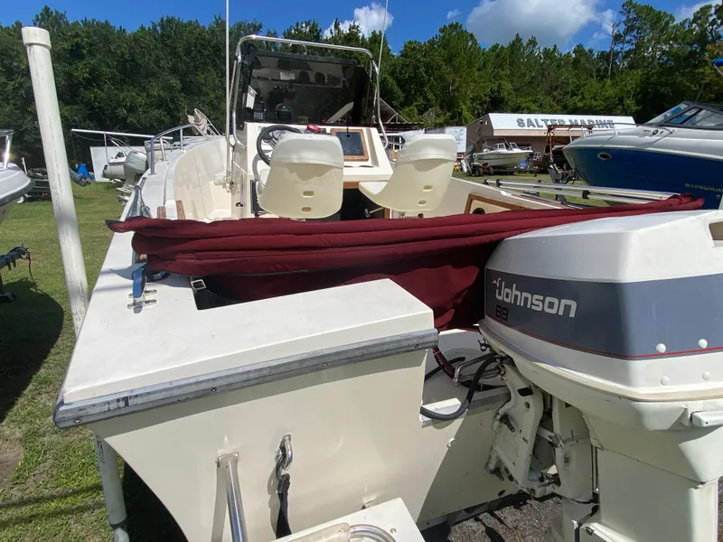 Slide: The Image of 1988 Pro-Line 17cc boat with Johnson outboard motor, parked outdoors. - 5