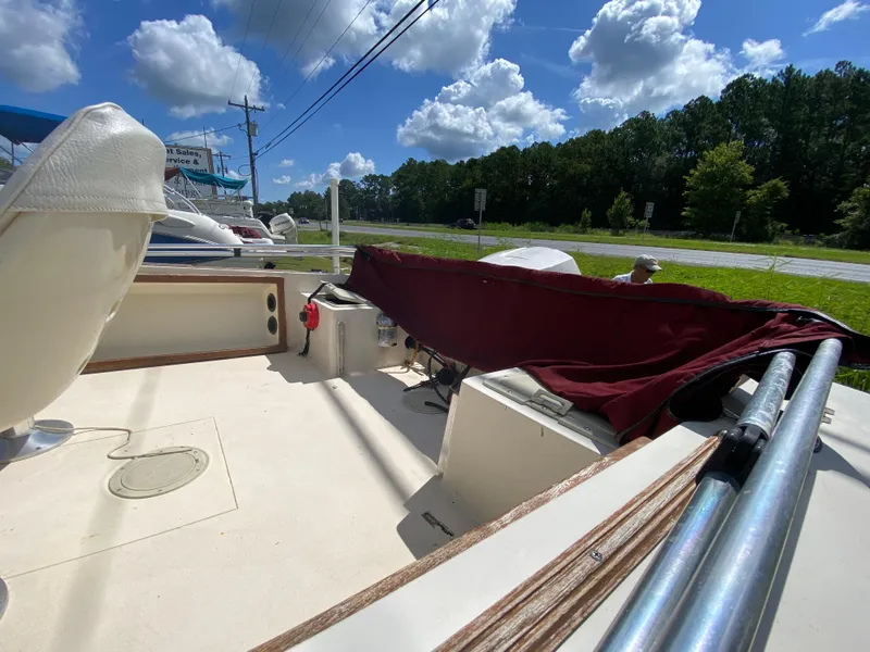 Slide: The Image of 1988 Pro-Line 17cc boat interior with seating, under a sunny sky. - 9