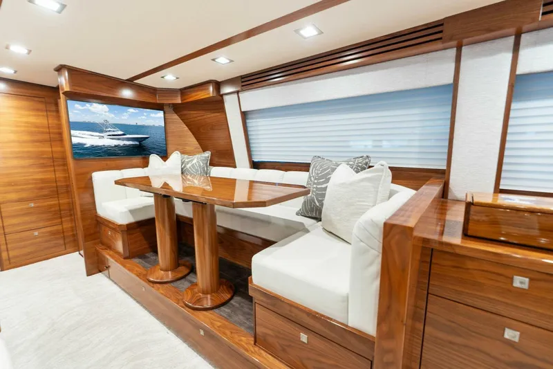 Slide: The Image of Luxurious interior of 2023 Viking 80 Convertible yacht with elegant wood finishes and plush seating. - 22