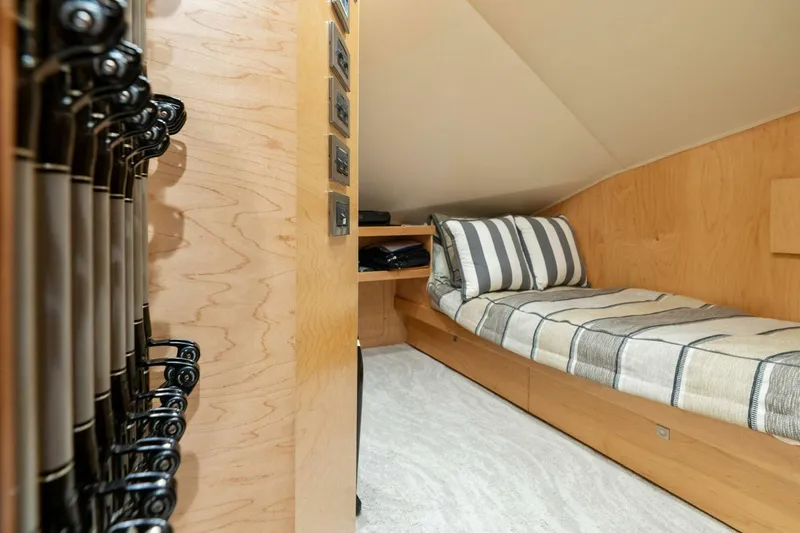 Slide: The Image of 2023 Viking 80 Convertible cabin with cozy bed and wooden interior design. - 24