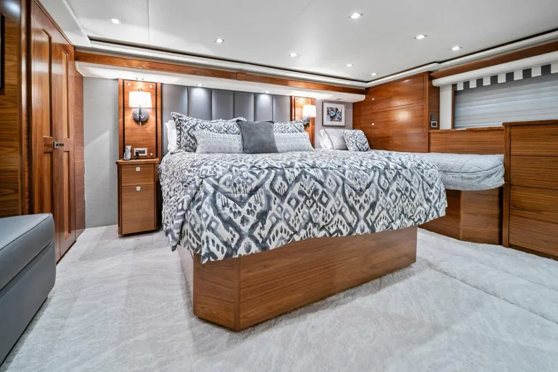 Slide: The Image of Luxurious bedroom interior of 2023 Viking 80 Convertible yacht with elegant wood finishes. - 27