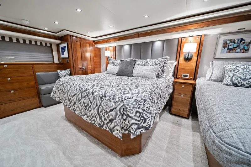 Slide: The Image of Luxurious bedroom interior of 2023 Viking 80 Convertible yacht with elegant bedding and wood accents. - 28