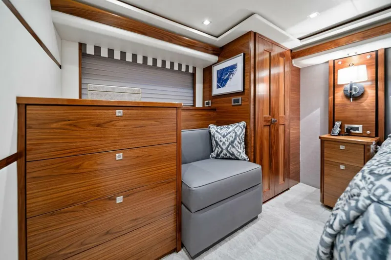 Slide: The Image of Luxurious interior of 2023 Viking 80 Convertible yacht with wood finishes and modern decor. - 29