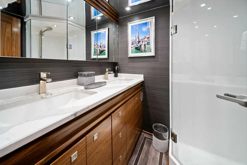Slide: The Image of Luxurious bathroom in 2023 Viking 80 Convertible yacht with dual sinks and modern decor. - 31