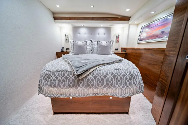 Slide: The Image of Luxurious bedroom interior of 2023 Viking 80 Convertible yacht with elegant bedding and wood accents. - 32