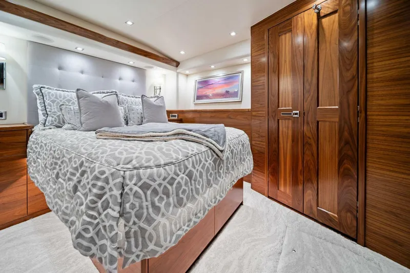 Slide: The Image of Luxurious bedroom interior of 2023 Viking 80 Convertible yacht with elegant wood finishes. - 33
