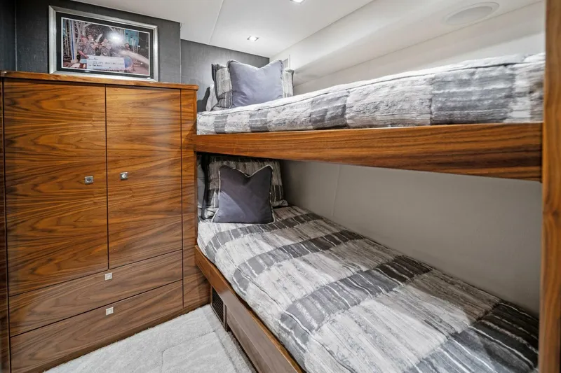 Slide: The Image of Bunk beds in 2023 Viking 80 Convertible yacht cabin with wooden cabinetry. - 36