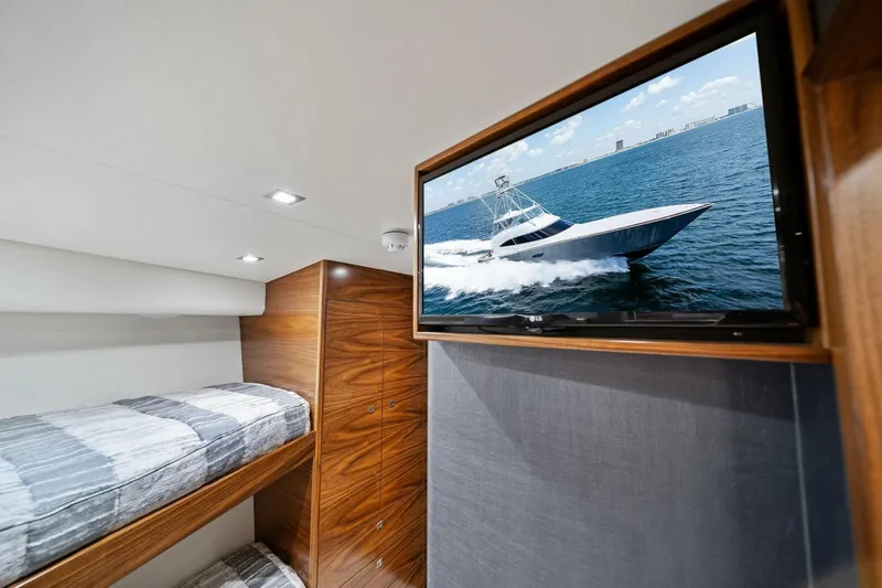Slide: The Image of Interior of 2023 Viking 80 Convertible yacht with bunk beds and wall-mounted TV. - 37