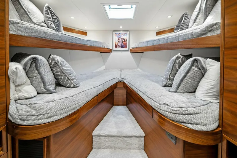 Slide: The Image of Luxurious cabin interior of 2023 Viking 80 Convertible yacht with cozy bunk beds. - 43