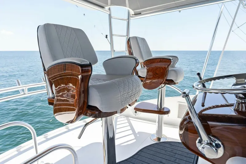 Slide: The Image of Luxurious seating on 2023 Viking 80 Convertible yacht, overlooking the ocean. - 47