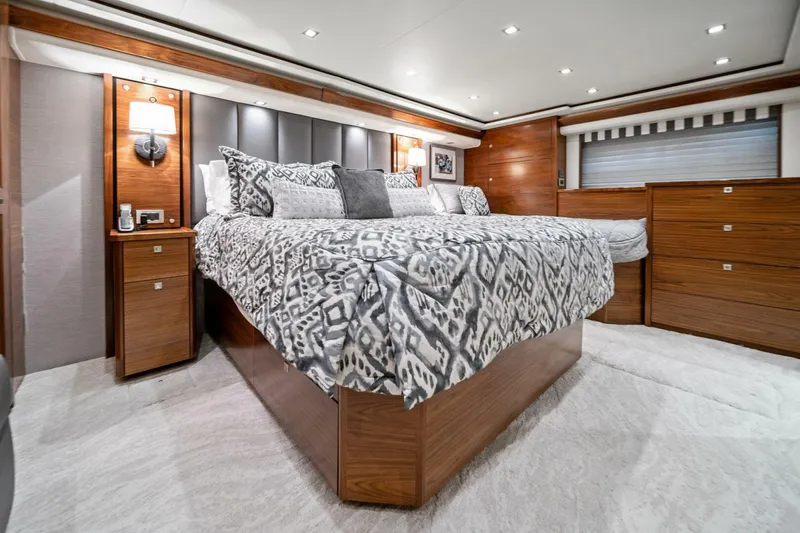Slide: The Image of Luxurious bedroom interior of 2023 Viking 80 Convertible yacht with elegant wood finishes. - 5