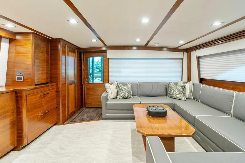 Slide: The Image of Luxurious interior of 2023 Viking 80 Convertible yacht with elegant wood finishes and plush seating. - 7