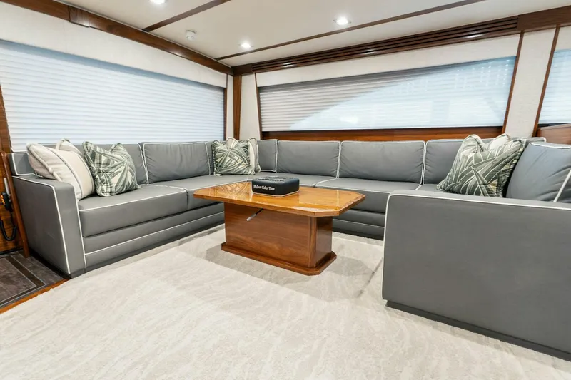Slide: The Image of Luxurious interior of 2023 Viking 80 Convertible yacht with elegant seating and wooden table. - 8