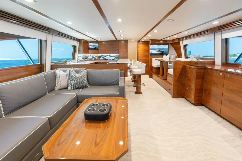 Slide: The Image of Luxurious interior of 2023 Viking 80 Convertible yacht with elegant wood finishes and plush seating. - 9