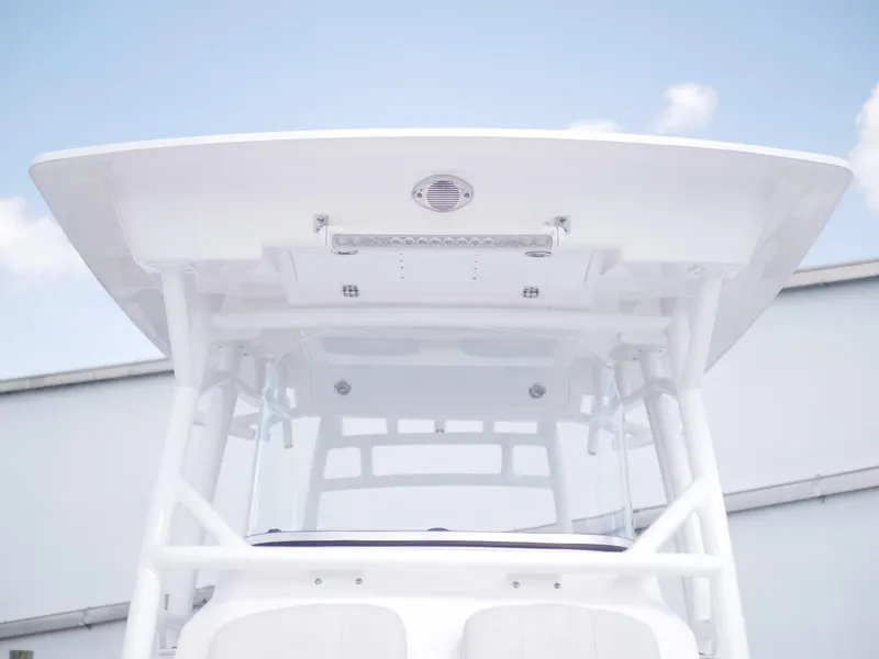Slide: The Image of 2021 Sea Fox 328 Commander boat's T-top and console against a clear sky. - 3