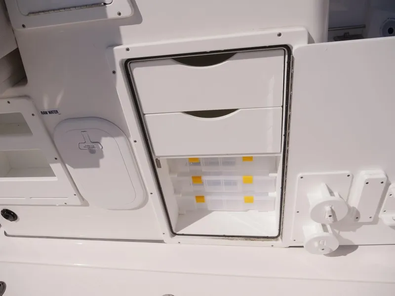 Slide: The Image of 2021 Sea Fox 328 Commander storage compartment with drawers and tackle boxes. - 7