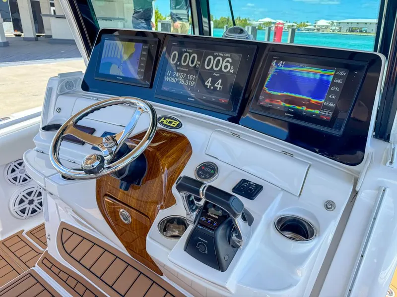 Slide: The Image of 2019 HCB 39 Speciale boat dashboard with advanced navigation displays and controls. - 17