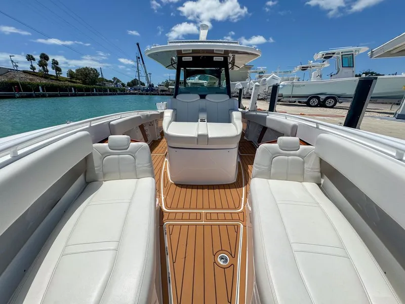 Slide: The Image of 2019 HCB 39 Speciale boat with luxurious seating and teak flooring, docked by the water. - 24