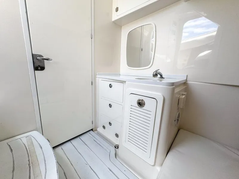 Slide: The Image of 2019 HCB 39 Speciale boat interior with sink, mirror, and storage cabinets. - 26