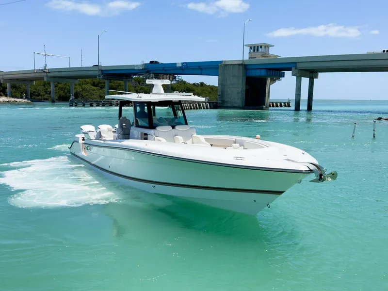 Slide: The Image of 2019 HCB 39 Speciale boat cruising in turquoise waters near a bridge. - 37
