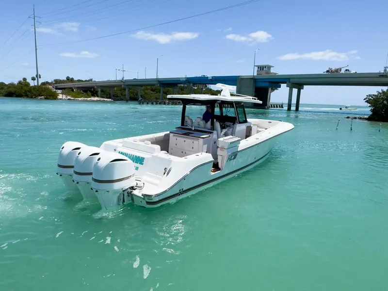 Slide: The Image of 2019 HCB 39 Speciale boat cruising in turquoise waters near a bridge. - 7