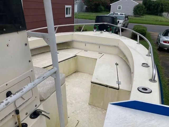 Slide: The Image of 1995 KenCraft Challenger 190 boat with spacious seating and storage, parked in a residential driveway. - 10